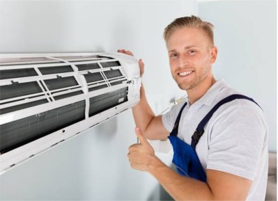 Worker installing air conditioner system in an office showing content about the good results.