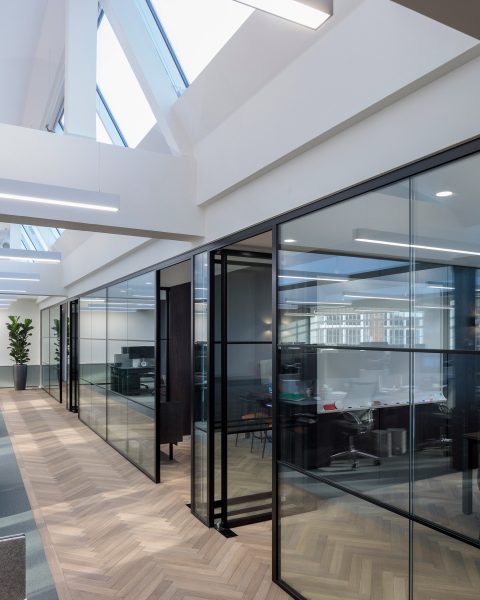 Glazed glass partitions fitted in office space to create separate meeting rooms.