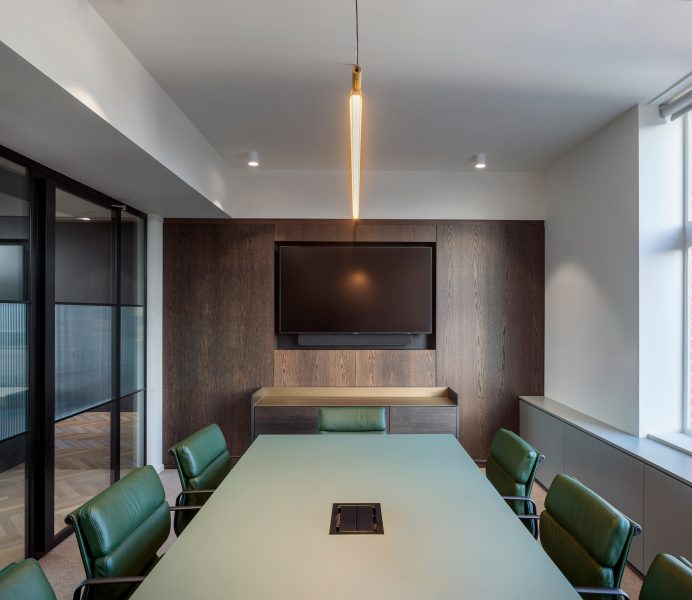 Green meeting room table and green leather chairs to decorate an office room.