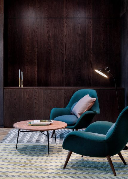 Blue cushioned chairs for a seating area.