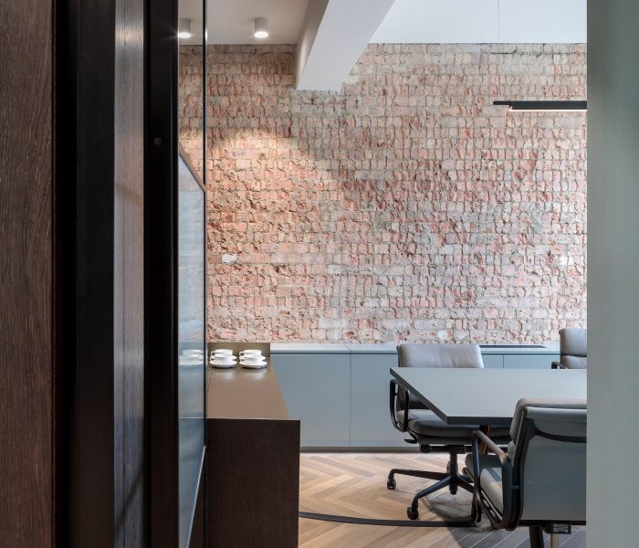 Feature wall with exposed brickwork in an office meeting room.
