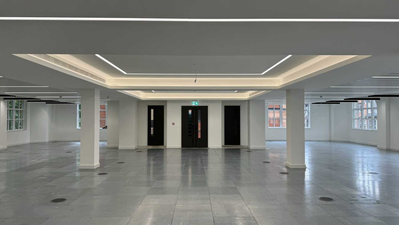 High-end office with white ceilings and LED strip lights.