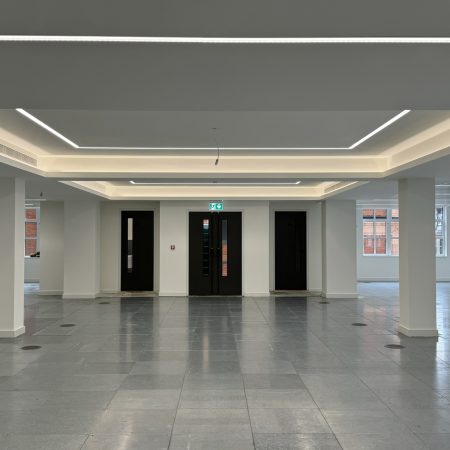 High-end office with white ceilings and LED strip lights.